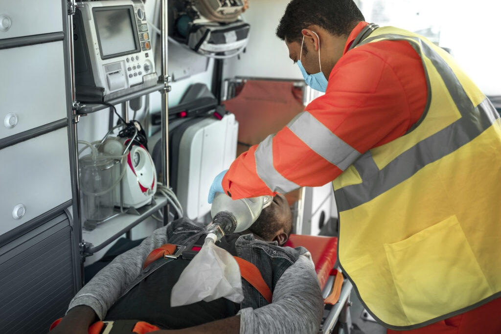 side view paramedic helping man