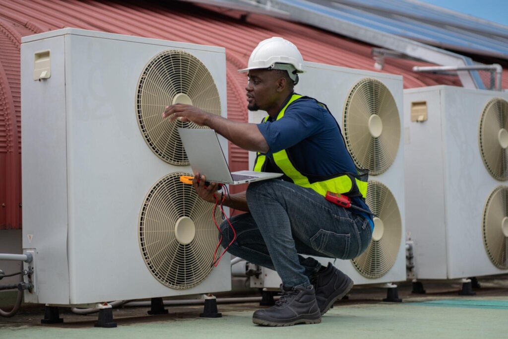 technician performing a scheduled inspection on rooftop HVAC units