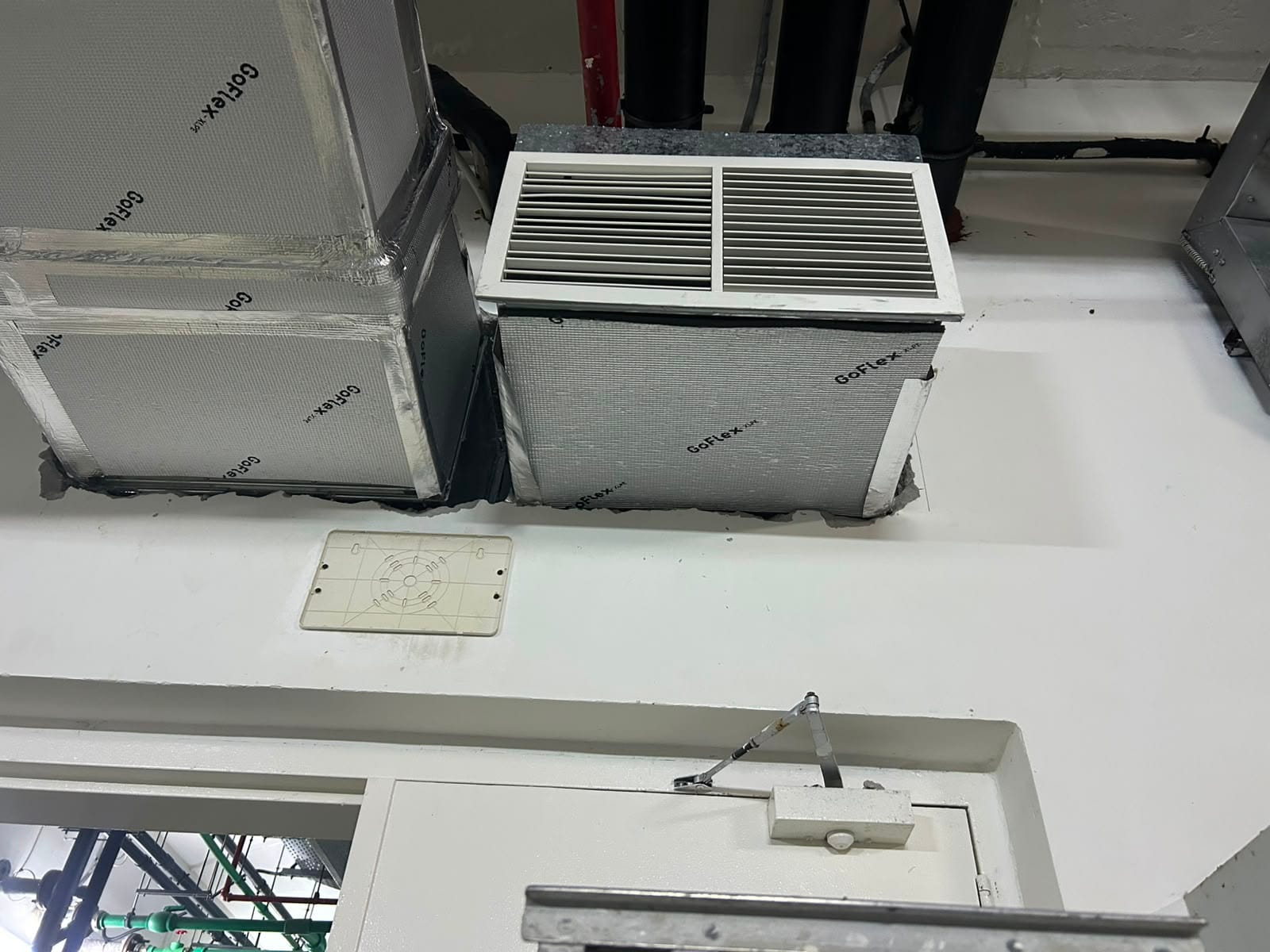 Ductwork and insulation above a ceiling void