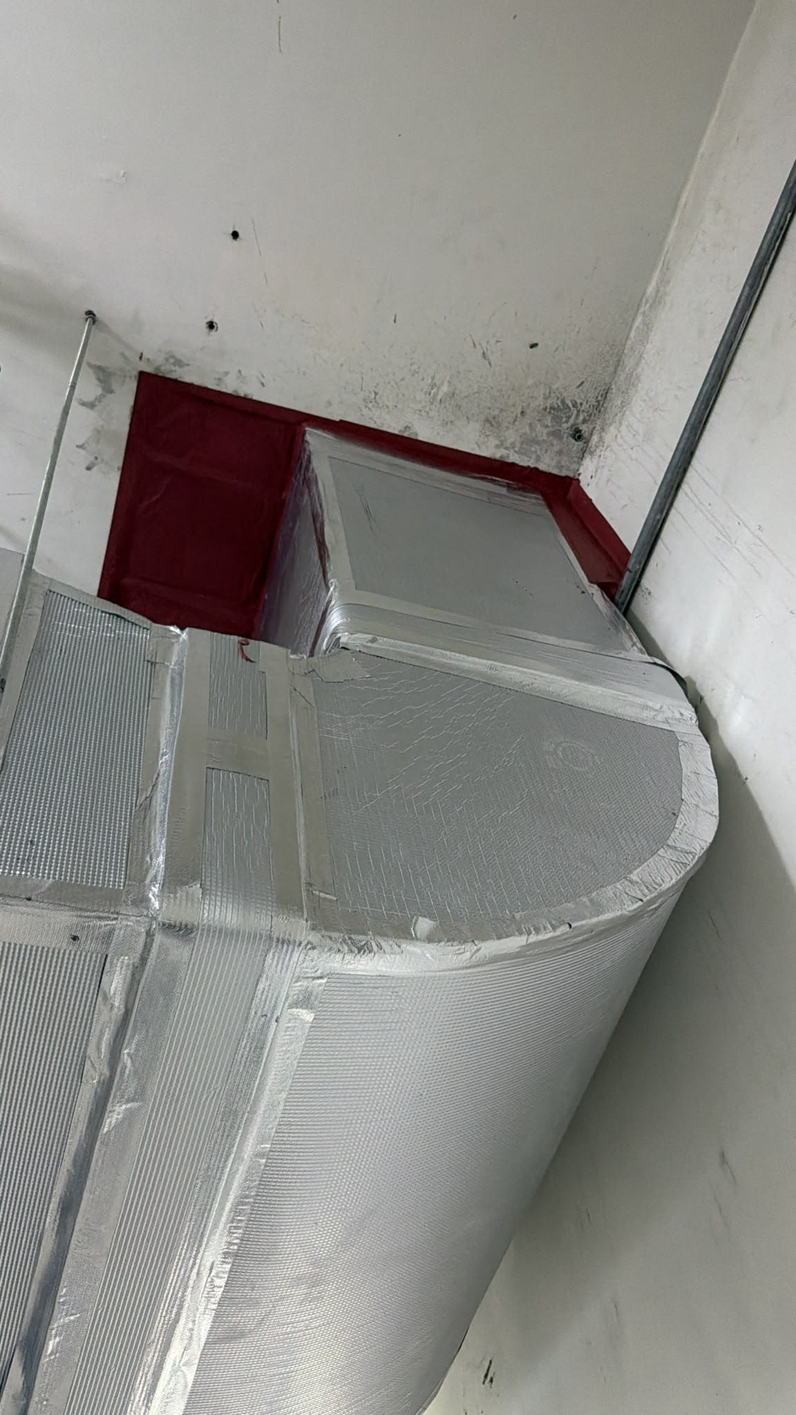 Ductwork and insulation above a ceiling void