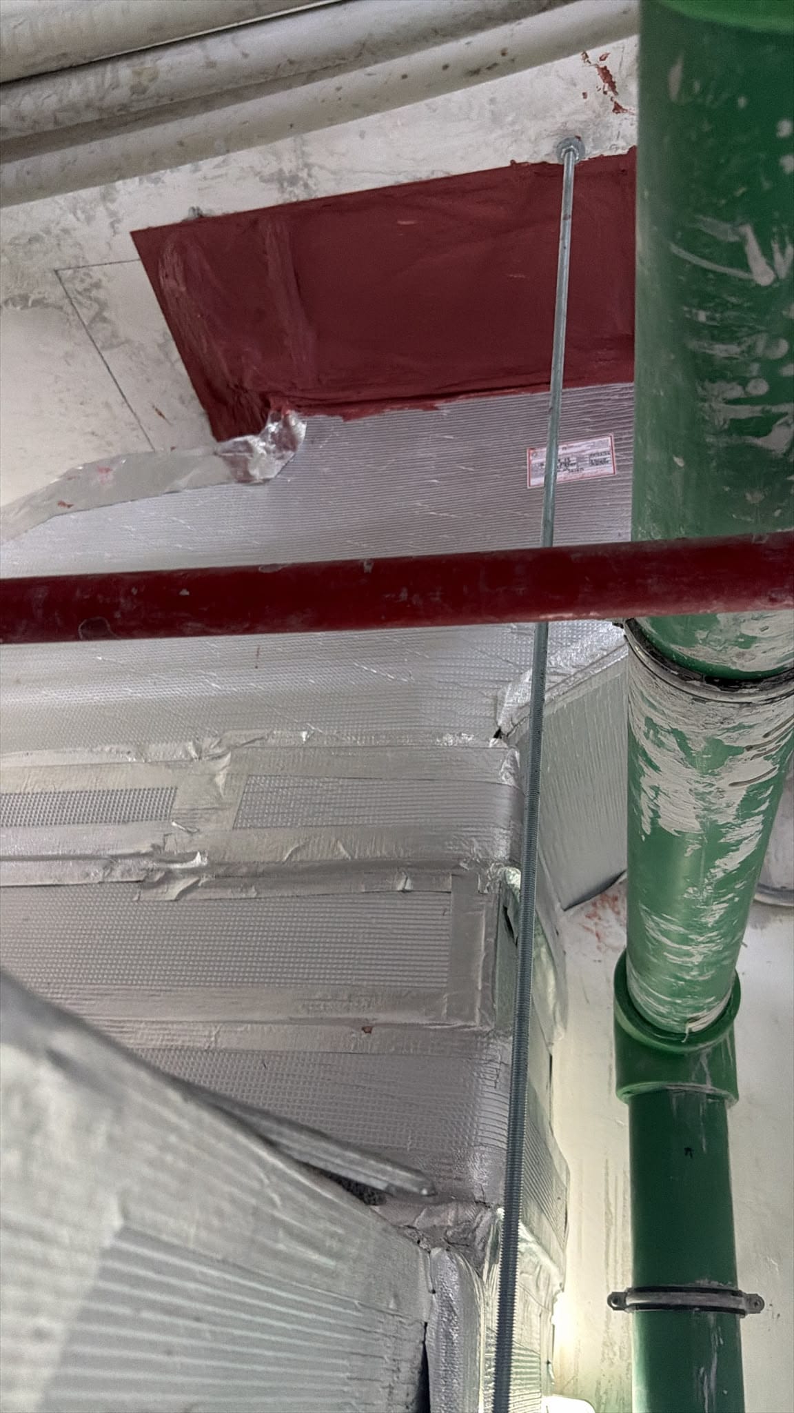 Ductwork and insulation above a ceiling void