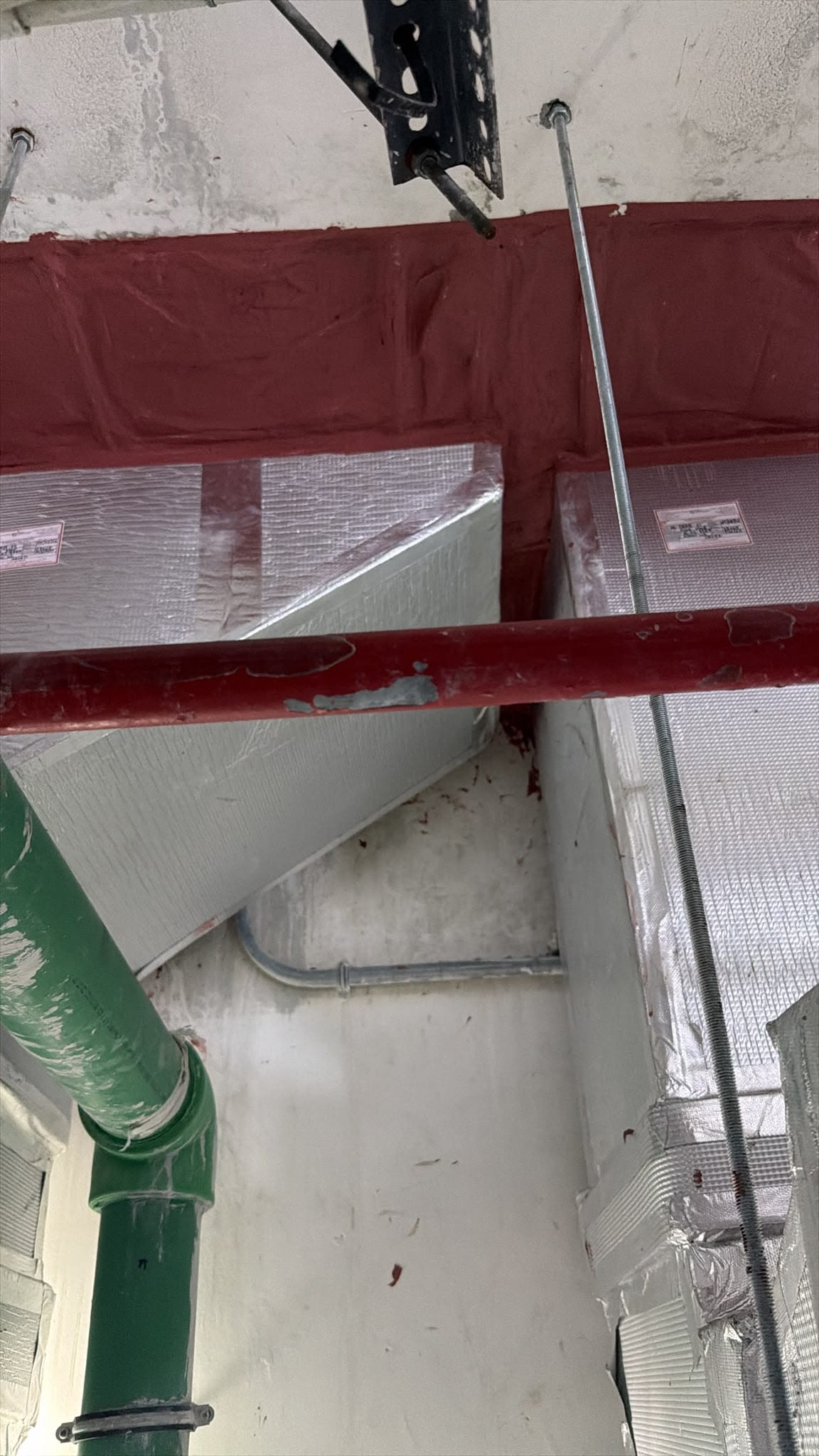 Ductwork and insulation above a ceiling void
