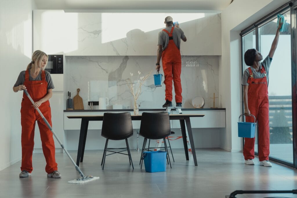 A professional painter rolling fresh paint onto an interior wall