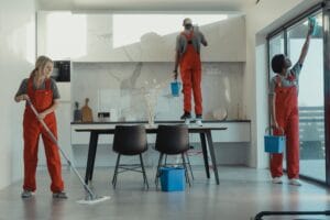 A professional painter rolling fresh paint onto an interior wall
